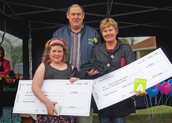 Matakohe School student Krystal Reyland (left) and St Joseph's School principal Glenis Guest show off the giant $500 cheques presented by Mayor Neil Tiller at the blue bag recycling launch.